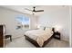 Serene bedroom featuring natural light, a ceiling fan, and a comfortable bed at 5088 S Quail St, Littleton, CO 80127