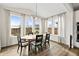 Sunlit dining room featuring an oval table, pendant lighting, and large windows with backyard views at 5088 S Quail St, Littleton, CO 80127