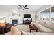 Cozy living room with a fireplace, modern furniture, and a large window for ample natural light at 5088 S Quail St, Littleton, CO 80127