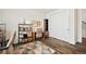 Cozy home office area featuring a modern desk, shelving, and sleek dark wood flooring at 5088 S Quail St, Littleton, CO 80127