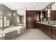 Modern bathroom featuring dual sinks, stylish tile, and a soaking tub at 1034 S Williams St, Denver, CO 80209