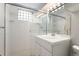 A bright bathroom featuring a modern vanity and a sleek glass-enclosed shower at 1034 S Williams St, Denver, CO 80209