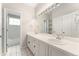 A well-lit bathroom with double sinks and a separate toilet and shower area at 1034 S Williams St, Denver, CO 80209