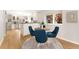 Bright dining area with wood floors, a round table with blue chairs, and a sunny window view at 1034 S Williams St, Denver, CO 80209