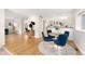 Bright dining area with wood floors, open to the kitchen, featuring a round table with four blue chairs at 1034 S Williams St, Denver, CO 80209