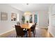 Bright dining room featuring a wooden table, six chairs, and a large window at 1034 S Williams St, Denver, CO 80209