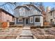 Charming two-story home features a stucco exterior, arched windows, and professionally landscaped front yard at 1034 S Williams St, Denver, CO 80209