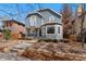 Charming two-story home features a stucco exterior, arched windows, and professionally landscaped front yard at 1034 S Williams St, Denver, CO 80209