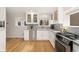 Bright kitchen with stainless steel appliances, granite countertops, and hardwood floors at 1034 S Williams St, Denver, CO 80209