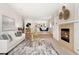 Bright and airy living room features a fireplace and opens to the dining area and kitchen at 1034 S Williams St, Denver, CO 80209