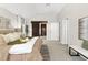 Light-filled bedroom with carpeted floors, closet, and ensuite bathroom at 1034 S Williams St, Denver, CO 80209