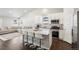 Modern kitchen with white cabinets, granite island, and stainless steel appliances at 507 Bonneville Ave, Fort Lupton, CO 80621