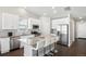 Modern kitchen with white cabinets, granite countertops and island, stainless steel appliances at 507 Bonneville Ave, Fort Lupton, CO 80621