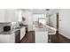 Modern kitchen with white cabinets, granite island, and stainless steel appliances at 507 Bonneville Ave, Fort Lupton, CO 80621