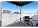 Covered patio with grill and snowy backyard at 507 Bonneville Ave, Fort Lupton, CO 80621