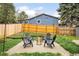 Backyard with patio seating area, fire pit, string lights, and a well-maintained lawn at 10618 W Layton Pl, Littleton, CO 80127