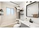 Bathroom featuring a tub-shower combination, with modern fixtures, and neutral decor at 10618 W Layton Pl, Littleton, CO 80127