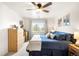Bright bedroom with a ceiling fan, natural light from the window, and comfortable, modern furnishings at 10618 W Layton Pl, Littleton, CO 80127