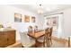 Elegant dining room featuring a classic wood table, chandelier, and natural light at 10618 W Layton Pl, Littleton, CO 80127
