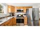 Well-appointed kitchen featuring stainless steel appliances, gas range, and ample storage at 10618 W Layton Pl, Littleton, CO 80127