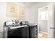 Modern laundry room featuring updated washer and dryer with decor at 10618 W Layton Pl, Littleton, CO 80127