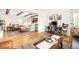 Bright living space with modern decor, wood floors, and open layout to the kitchen at 10618 W Layton Pl, Littleton, CO 80127