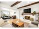 Spacious living room featuring a fireplace, hardwood floors, and ample natural light at 10618 W Layton Pl, Littleton, CO 80127