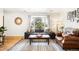 Cozy living room with a large bay window offering plenty of natural light at 10618 W Layton Pl, Littleton, CO 80127