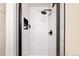 Updated shower with sleek black fixtures, niche storage, and light gray tile for a clean aesthetic at 10618 W Layton Pl, Littleton, CO 80127