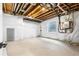 Unfinished basement with concrete floors, white walls, and visible beams and piping at 8864 Moonshimmer Trl, Littleton, CO 80125