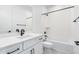 Contemporary bathroom featuring a sleek vanity, modern fixtures, white tiles, and lots of natural light at 8864 Moonshimmer Trl, Littleton, CO 80125