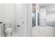 Clean half bathroom featuring white marble floors and a walk-in shower at 8864 Moonshimmer Trl, Littleton, CO 80125