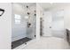 Bathroom featuring marble floors, walk-in shower with black trim and a walk-in closet at 8864 Moonshimmer Trl, Littleton, CO 80125