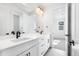 Elegant bathroom with dual sinks, a large mirror, modern lighting, and sleek cabinetry, creating a spa-like retreat at 8864 Moonshimmer Trl, Littleton, CO 80125