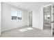 A bright bedroom with neutral carpet, white walls, and large window for natural light at 8864 Moonshimmer Trl, Littleton, CO 80125