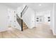 Bright entryway featuring hardwood floors, a staircase, and view of the Gathering room at 8864 Moonshimmer Trl, Littleton, CO 80125