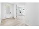 Light-filled entryway features light wood floors, white door, and view of the adjacent room at 8864 Moonshimmer Trl, Littleton, CO 80125