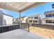 Covered patio with a black metal railing overlooking an unfinished backyard, with neighboring houses in the background at 8864 Moonshimmer Trl, Littleton, CO 80125