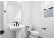 Powder room features a pedestal sink, toilet, and small window for natural light at 8864 Moonshimmer Trl, Littleton, CO 80125