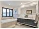 Bright bathroom with a double vanity, an illuminated mirror, and a soaking tub at 4853 S Crystal St, Aurora, CO 80015