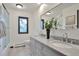 Bright bathroom featuring a double vanity, granite countertops, and a shower at 4853 S Crystal St, Aurora, CO 80015