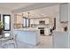Bright kitchen featuring white cabinets, stainless steel appliances, stylish backsplash, and a central island with bar seating at 4853 S Crystal St, Aurora, CO 80015