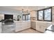 Open kitchen with white cabinets, stainless steel appliances, and island with a farmhouse sink at 4853 S Crystal St, Aurora, CO 80015