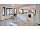 Bright kitchen with stainless steel appliances, white cabinets, eat-in table and chairs, and large windows at 4853 S Crystal St, Aurora, CO 80015