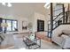 Open-concept living room with large window, stylish decor, and view of the entrance at 4853 S Crystal St, Aurora, CO 80015