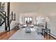 Spacious living room with high ceilings and open layout connecting to the dining area and stairway at 4853 S Crystal St, Aurora, CO 80015
