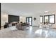 Expansive living room with a modern fireplace, bay windows and a dining area bathed in natural light at 4853 S Crystal St, Aurora, CO 80015