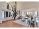 Bright living room features an open floor plan, hardwood floors, and a staircase to the upper level at 4853 S Crystal St, Aurora, CO 80015
