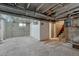 Unfinished basement with concrete floor, exposed ceiling, and access to the upper floor at 2421 W 38Th Ave, Denver, CO 80211