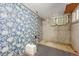 Finished basement space featuring floral wallpaper, and a window at 2421 W 38Th Ave, Denver, CO 80211